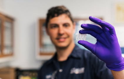 Molecular biologist in a brewing lab holding test tube