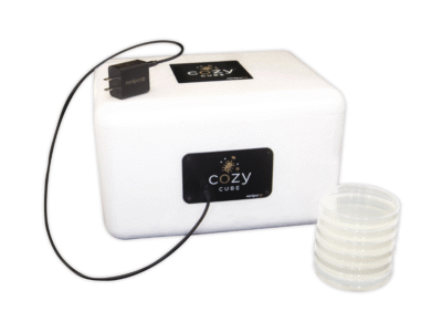 Cozy Cube alongside USB-C cord and petri plates