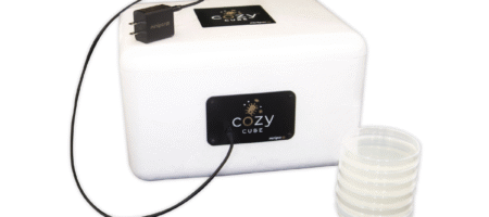 Cozy Cube alongside USB-C cord and petri plates